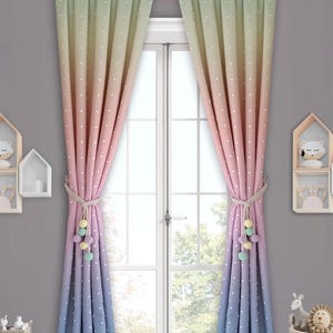 May include: A pair of ombre curtains with white polka dots. The curtains are green, yellow, pink, and blue. The curtains have a tassel tieback with pom poms.