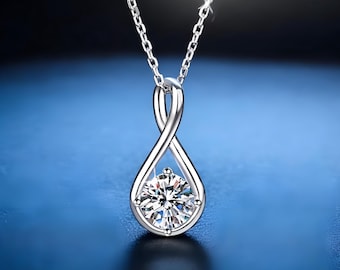 May include: A silver infinity pendant necklace with a clear round cubic zirconia stone.