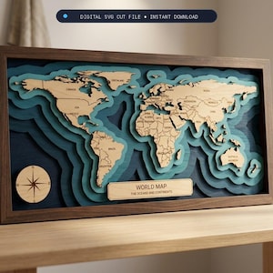 May include: A multi-layered wooden world map wall art piece in a dark brown frame. The map features light wood continents against deep blue and teal ocean layers. A circular compass rose and a plaque labeled WORLD MAP THE OCEANS AND CONTINENTS are included.