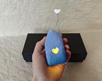 Cute glowing house. Small night lamp. Night light house.