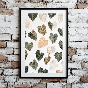 May include: A framed print featuring a watercolor pattern of green, brown, and white leaves on a white background.