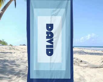 May include: A blue beach towel with a white border and a blue rectangle in the center. The rectangle has the name "DAVID" printed in white letters.