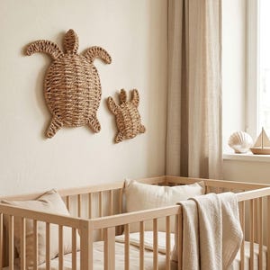 a cozy nursery with a wooden crib and two woven turtle wall decorations. The crib has a blanket draped over it, creating a warm and inviting atmosphere.