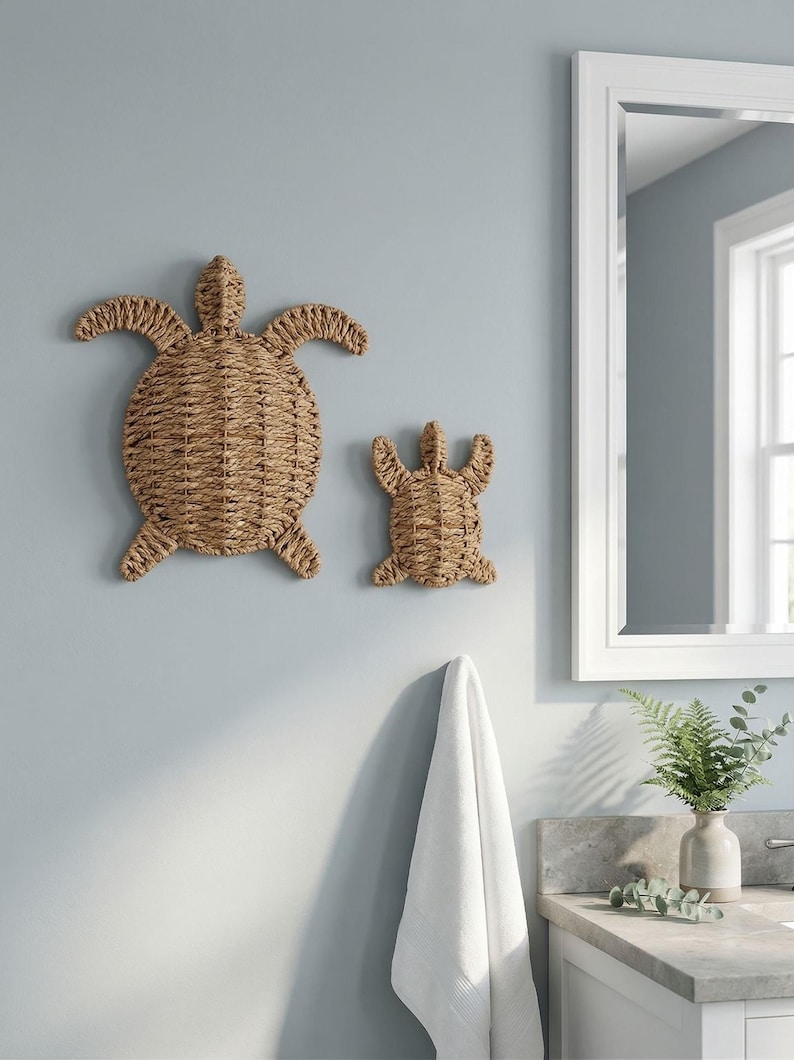 a bathroom with a large mirror, a towel rack, and two woven turtle-shaped wall decorations.