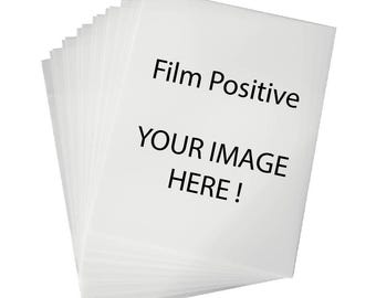 May include: A stack of white film positive sheets with the text "Film Positive" and "Your Image Here!" printed on the top sheet.