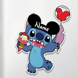 May include: A blue cartoon character, wearing a black hat with the name "NAME" on it, holds a red Mickey Mouse balloon and an ice cream cone. The ice cream has pink and yellow layers. The character has large eyes and a wide smile.