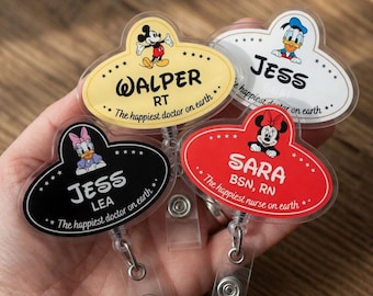 May include: Four Disney-themed name badges with cartoon characters Mickey Mouse, Donald Duck, Daisy Duck, and Minnie Mouse. Each badge has a different color background and includes a name, title, and the phrase "The happiest doctor on earth" or "The happiest nurse on earth."