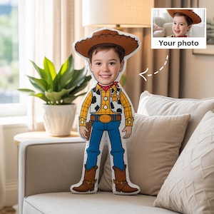 May include: A custom-made pillow shaped like a cartoon cowboy, featuring a child's face. The pillow has a brown cowboy hat, a yellow plaid shirt, blue jeans, and brown boots. The text "Your photo" is in the upper right corner.