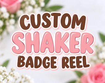 May include: A graphic sign featuring the text CUSTOM SHAKER BADGE REEL in a bold, rounded font. The word CUSTOM is in dark brown, SHAKER is in light pink, and BADGE REEL is in dark brown, all with a white outline against a floral background.
