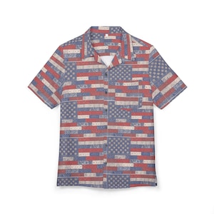 May include: Short-sleeved shirt with a patchwork design featuring the American flag. The shirt has a classic collar, a chest pocket, and a button-up front. The pattern includes red, white, and blue elements.
