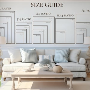 May include: A wall with a size guide for picture frames, showing various ratios and dimensions in inches. The text "SIZE GUIDE" is at the top. The guide includes 2:3, 3:4, 4:5, 11:14, and A1-A4 ratios. The wall is above a white sofa.