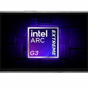 May include: A handheld gaming console with a metallic grey finish, featuring a central screen displaying the Intel Arc Extreme G3 logo. The device includes a directional pad, two analogue sticks with light blue rings, and standard action buttons.