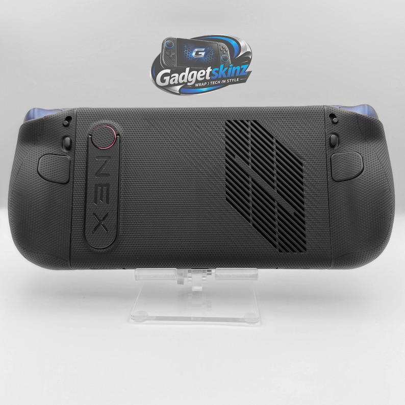 May include: A black handheld gaming console with a textured grip surface, featuring a prominent ventilation grille on the back, a vertical OneX branding panel with a circular red accent, and two rear-facing buttons on the left and right sides.