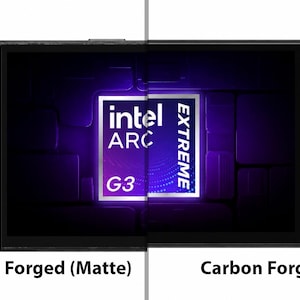 May include: A handheld gaming console featuring a split-screen design with a matte carbon forged finish on the left and a glossy carbon forged finish on the right. The screen displays the text Intel Arc Extreme G3. The device has black buttons.