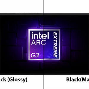 May include: A handheld gaming console featuring a black frame with a split finish, showing a glossy piano black side on the left and a matte black side on the right. The screen displays an Intel Arc Extreme G3 logo. The device has two joysticks with blue rings.