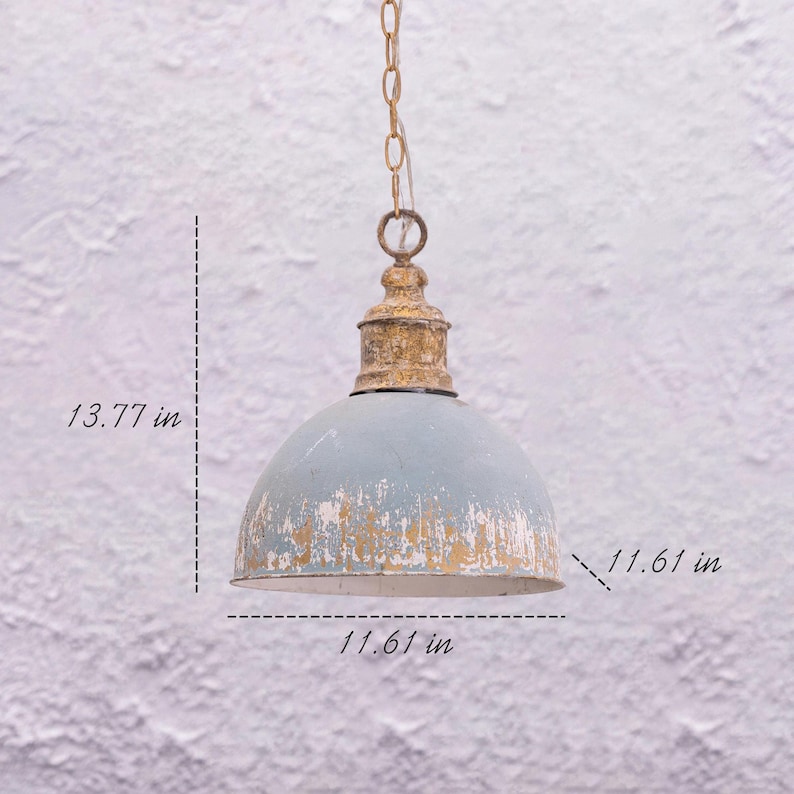 May include: A distressed, light blue pendant light with a gold-colored top and chain. The shade is 11.61 inches in diameter and 13.77 inches high. The light fixture has a vintage, rustic aesthetic.