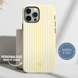 May include: A yellow and white striped phone case with a black border. The case has a gold monogram of the initials "AS" and the text "PERSONALIZED MAKE IT YOURS". A blue circle with the text "PRODUCED IN USA" and "SHIPS FAST" is also visible.