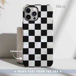 May include: A smartphone case featuring a black and white checkered pattern with a pearlescent finish. The case includes the letters AS in a serif font near the bottom. The text MALVA is visible in the top right corner, and the word PERSONALIZED is printed with an arrow pointing toward the case.