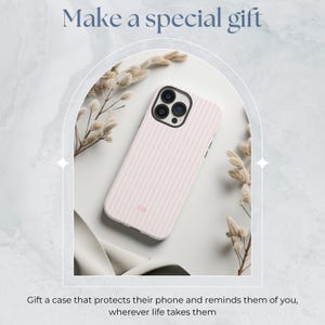 May include: A pink and white striped phone case with a camera lens cutout and the initials "EB" printed on the back.