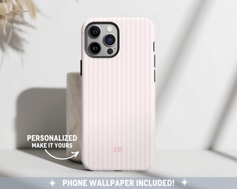 Elegant phone case featuring a minimalist vertical stripe pattern in soft pink. The design includes a customizable monogram near the bottom, allowing for personalization. A classic and timeless pattern.