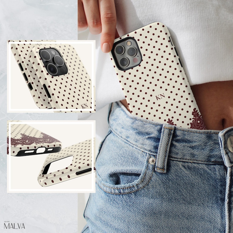 May include: A cream-colored smartphone case featuring a dark brown polka dot pattern, the initials KN, and a decorative dark brown floral accent at the bottom corner. The case includes a cutout for the camera lens and side button access points.