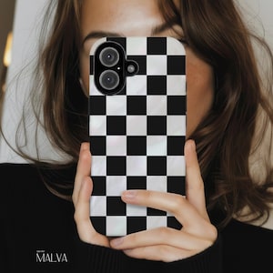 May include: A rectangular smartphone case featuring a high-contrast black and white checkered pattern. The design consists of alternating solid black and white squares across the entire surface, with a circular cutout for the camera lens.
