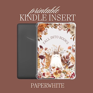 Puede incluir: Inserción imprimible para Kindle Paperwhite con un diseño de otoño. El diseño presenta un fantasma con una corona floral, rodeado de hojas y flores de otoño. El texto "Fall into Books" está escrito en blanco.