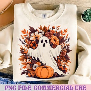 May include: Cream-colored sweatshirt featuring a white ghost design with a floral arrangement of orange, brown, and white flowers and leaves. An orange pumpkin sits below the ghost. The text "PNG FILE COMMERCIAL USE" is at the bottom.