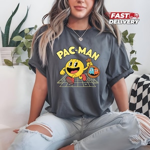 Cartoon Pac-Man T-Shirt - Running with Ghosts Design - Arcade Game Character Tee - Playful Retro Gaming Shirt - Pac-Man Nostalgia Tee