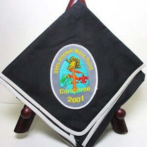 May include: Black square handkerchief with a white and gray border. An embroidered patch in the center reads "39th Annual West Point Camporee 2001" with a colorful emblem of a helmet and a cross.