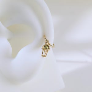 Peut inclure: Boucle d'oreille en or avec un pendentif en forme de gobelet &agrave; caf&eacute; glac&eacute; vert.
