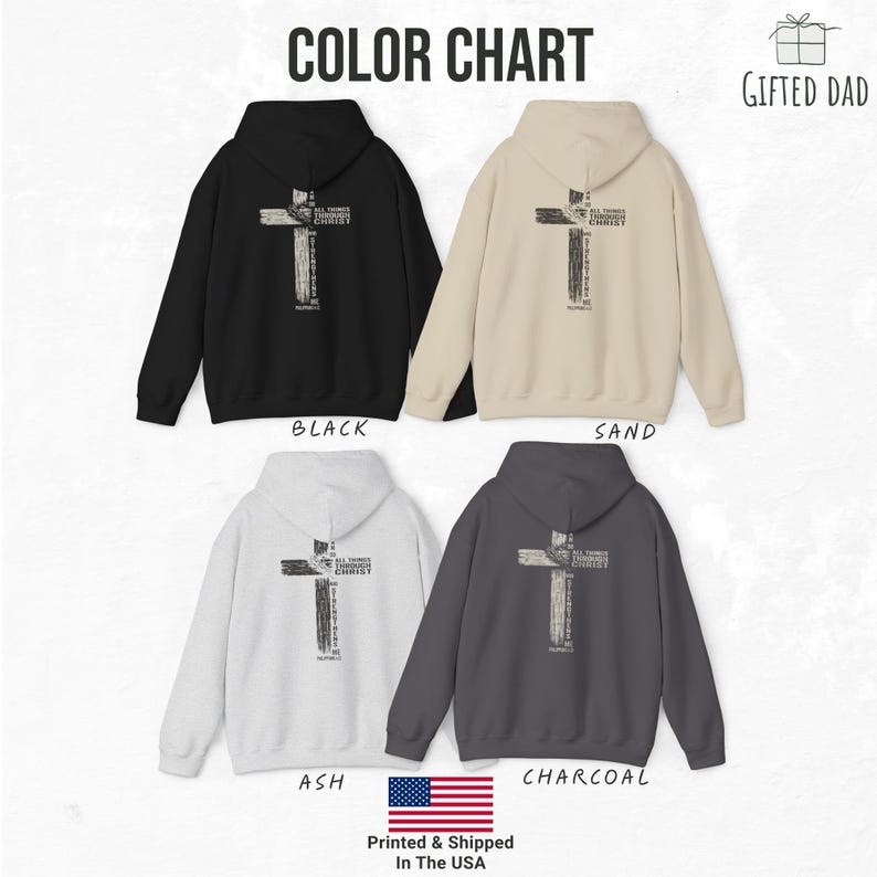 K&ouml;nnte beinhalten: Farbkarte mit Kapuzenpullovern in Schwarz, Sand, Aschgrau und Anthrazit. Jeder Hoodie hat ein Kreuzdesign auf dem R&uuml;cken mit dem Text "ALL THINGS THROUGH CHRIST". Der Text "GIFTED DAD" befindet sich in der oberen rechten Ecke.