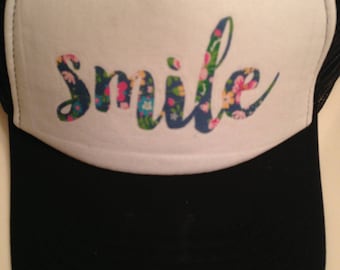 Black and white womens floral smile trucker hat