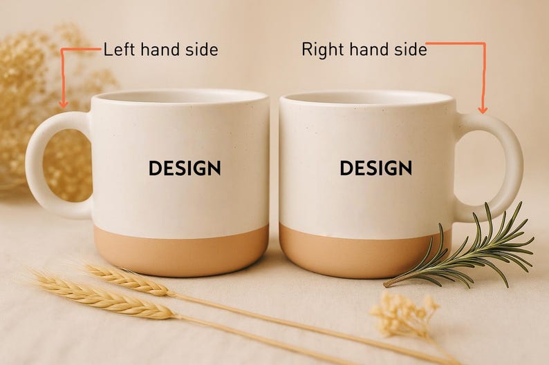 May include: Two white ceramic mugs with a tan base and handle, each displaying the word "DESIGN" in black. The mugs are set on a neutral surface, accompanied by wheat stalks and greenery.