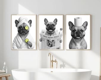 May include: Three framed black and white prints featuring French Bulldogs in humorous bathroom scenes. One dog wears a spa robe and cucumber slices, another reads a newspaper, and the third has a toilet paper roll on its head.