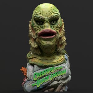 Peut inclure: Buste vert et beige de la créature du Black Lagoon. Le buste présente les traits distinctifs du visage de la créature, notamment de grands yeux et des lèvres épaisses. La base du buste porte l'inscription "Creature from the Black Lagoon" en vert.