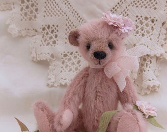 Rosabelle a miniature teddy bear on rose print cushion