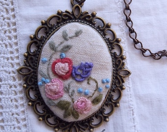 Embroidery - pendant with hand embroidered flowers in brass setting with matching chain
