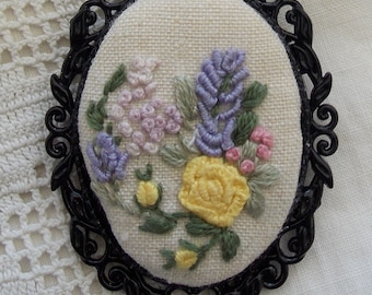 Embroidery - brooch with hand embroidered flowers in black ornamental setting