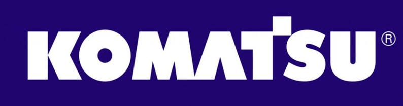 May include: The word "KOMATSU" in bold white letters is displayed against a dark blue background. The registered trademark symbol is in the upper right corner of the "SU".