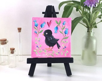 Small original decorative painting of a black bird on pink background - Tiny original painting on easel, ready to display as shelf decor