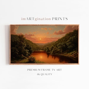 Puede incluir: Una impresión de paisaje enmarcada titulada imARTgination PRINTS, PREMIUM FRAME TV ART 4K QUALITY. La obra muestra una puesta de sol sobre un río que serpentea entre colinas verdes, con nubes de color naranja y rosa en el cielo.