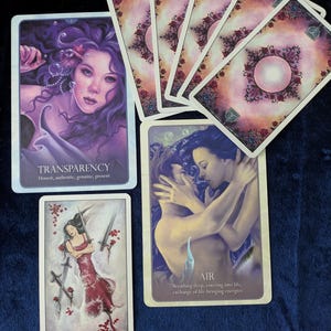 May include: A collection of tarot cards featuring illustrations of figures and symbols. The cards display images of a woman underwater, a couple embracing, and a woman with swords. The text on the cards includes "TRANSPARENCY", "FOUR of Swords", and "AIR".