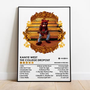 May include: A framed poster featuring the album art for Kanye West's "The College Dropout." The artwork depicts a bear mascot in a brown jacket and blue jeans, seated on a wooden bench. The poster includes the album's tracklist and release date.