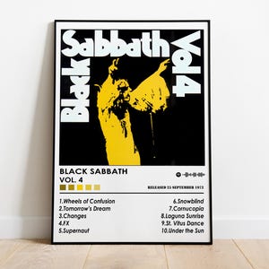 May include: Black Sabbath Vol. 4 album art poster in a black frame. The poster features a yellow silhouette on a black background, with the band's name and album details in white. The tracklist is also visible.