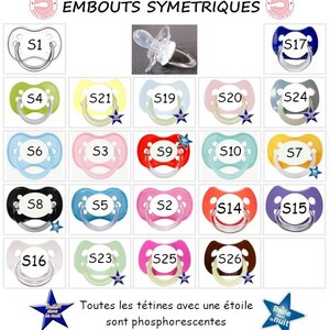 May include: A collection of twenty-one pacifiers in various colors including red, blue, pink, green, yellow, black, and clear, each labeled with an S-number. Some feature a blue star icon indicating glow-in-the-dark properties, with text EMBOUTS SYMETRIQUES.