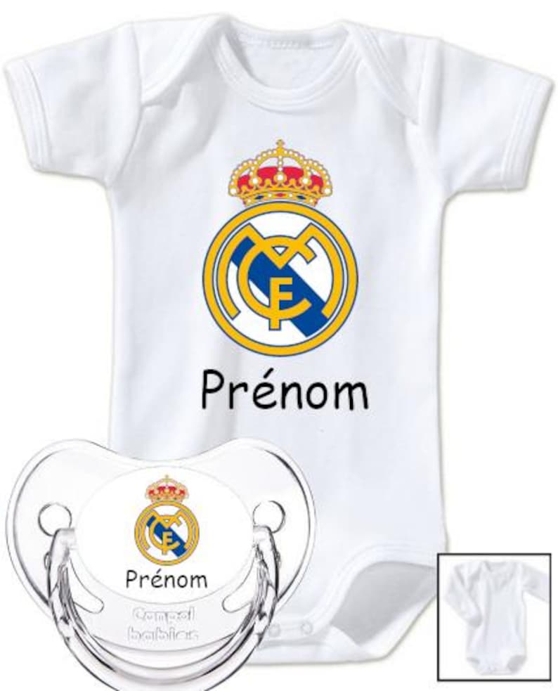 May include: White baby onesie and pacifier set featuring the Real Madrid logo in yellow, blue, and red. The word "Pr&eacute;nom" is printed in black on both items. The pacifier is clear with the brand name "Canpol babies".