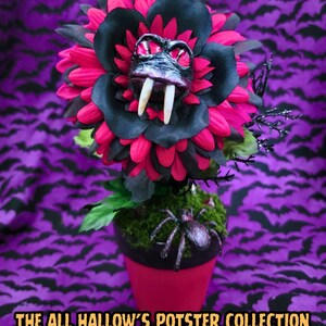 May include: A decorative potted plant featuring a large, multi-layered flower with black and hot pink petals, a central creature face with red eyes and two white fangs, and a small black spider on green moss. Text reads: THE ALL HALLOW'S POTSTER COLLECTION.