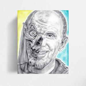 May include: A black and white pencil drawing of a man with one side of his face appearing as a human and the other side appearing as a skull. The background is yellow and blue.
