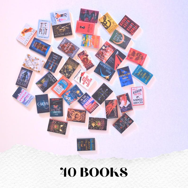 May include: A collection of 40 miniature books with various titles and colorful covers, arranged on a white and pink surface. The books are of different sizes and shapes, with titles such as "Morning Star" and "The Plot". The text "40 BOOKS" is at the bottom.